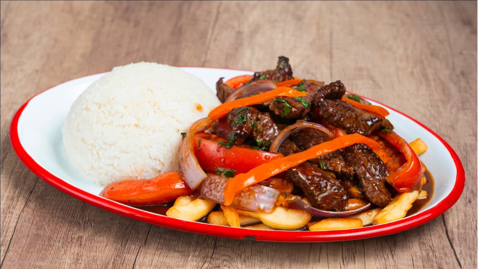 Lomo Saltado — Peruvian stir-fried beef with onions, tomatoes, and crispy fries